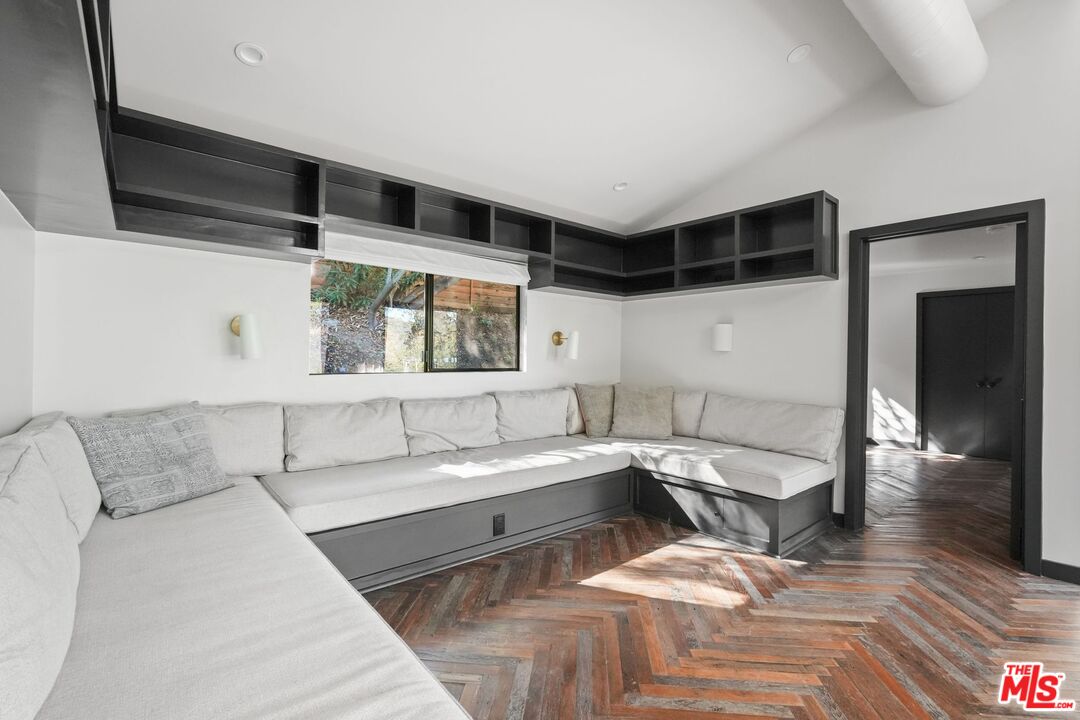 21273 Entrada Road Topanga, CA 90290 - Photo 15 of 70 a living room with a couch and a wooden floor