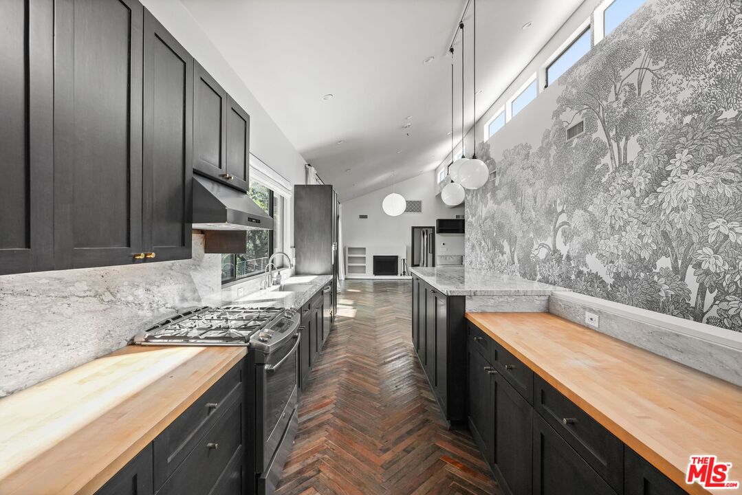 21273 Entrada Road Topanga, CA 90290 - Photo 27 of 70 a kitchen with stainless steel appliances granite countertop a sink stove and refrigerator