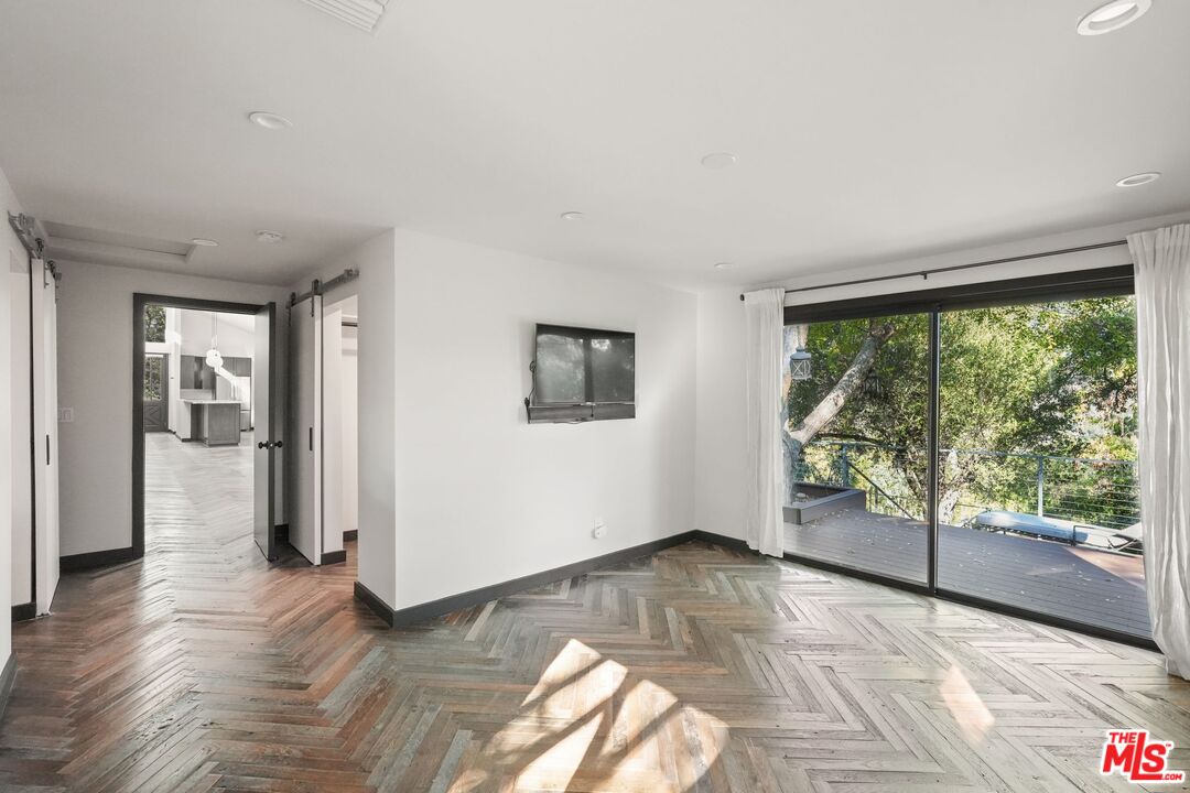 21273 Entrada Road Topanga, CA 90290 - Photo 32 of 70 a view of empty room with wooden floor and floor to ceiling window