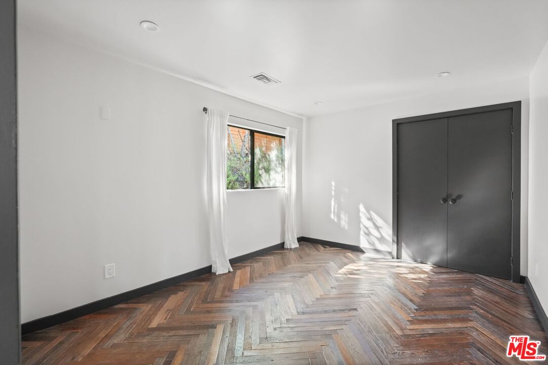 21273 Entrada Road Topanga, CA 90290 - Photo 41 of 70 an empty room with wooden floor and windows