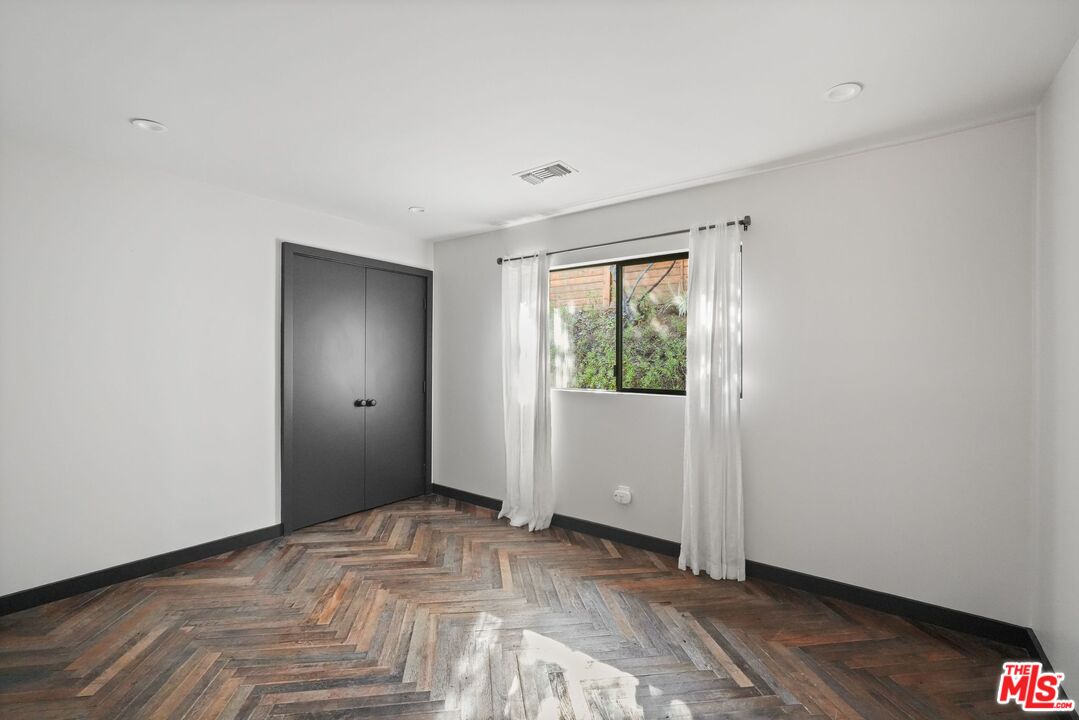 21273 Entrada Road Topanga, CA 90290 - Photo 45 of 70 a view of an empty room with wooden floor and a window