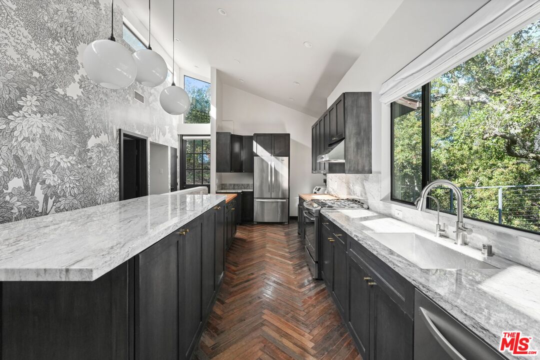 21273 Entrada Road Topanga, CA 90290 - Photo 6 of 70 a large kitchen with kitchen island a large window a sink and stainless steel appliances