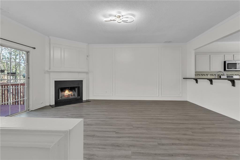 9155 Nesbit Ferry Road, Unit 96 Alpharetta, GA 30022 - Photo 11 of 46 a view of empty room with a fireplace and wooden floor