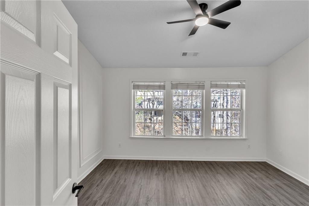 9155 Nesbit Ferry Road, Unit 96 Alpharetta, GA 30022 - Photo 17 of 46 a view of an empty room with a window and wooden floor