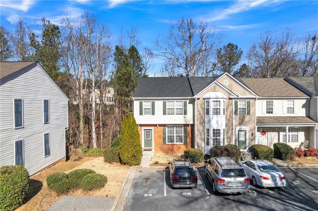 9155 Nesbit Ferry Road, Unit 96 Alpharetta, GA 30022 - Photo 2 of 46 a front view of a house with a yard