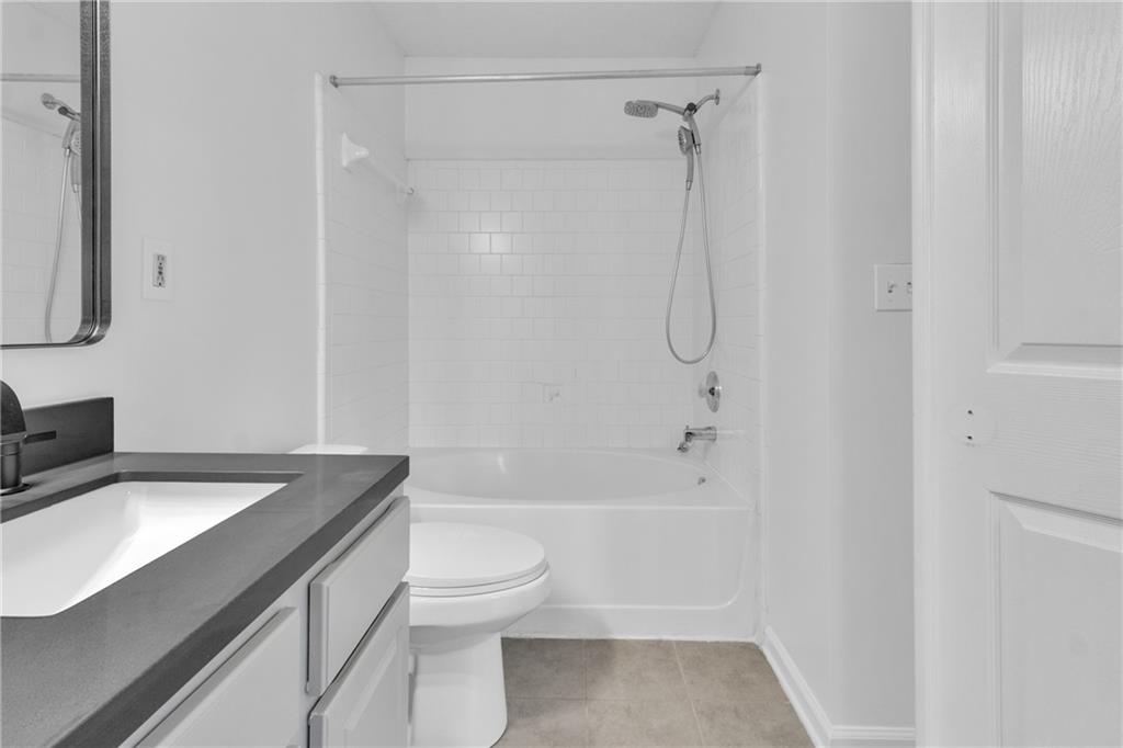 9155 Nesbit Ferry Road, Unit 96 Alpharetta, GA 30022 - Photo 21 of 46 a bathroom with a granite countertop sink toilet and shower