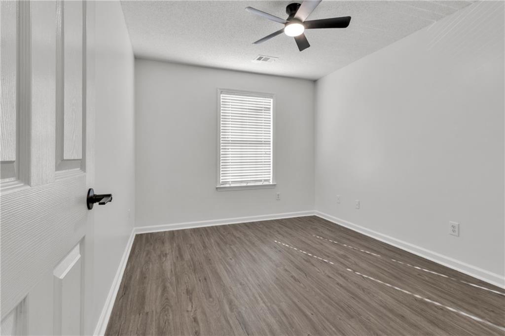 9155 Nesbit Ferry Road, Unit 96 Alpharetta, GA 30022 - Photo 28 of 46 wooden floor in an empty room with a window