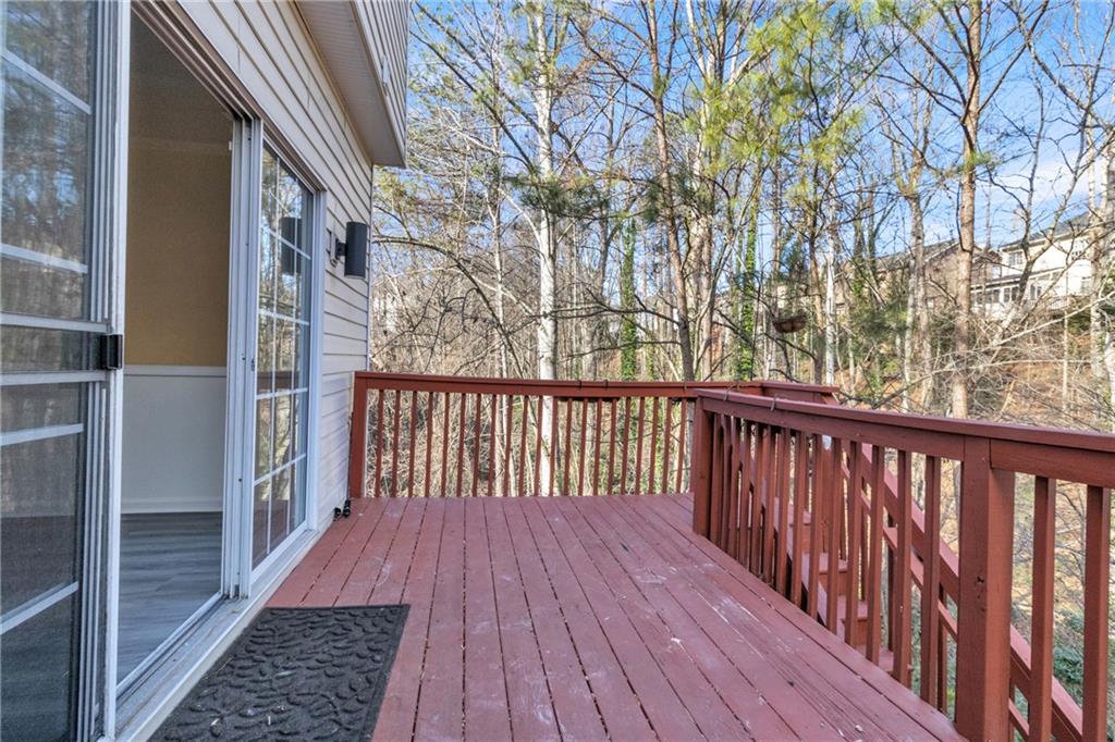 9155 Nesbit Ferry Road, Unit 96 Alpharetta, GA 30022 - Photo 39 of 46 a balcony with wooden floor and fence