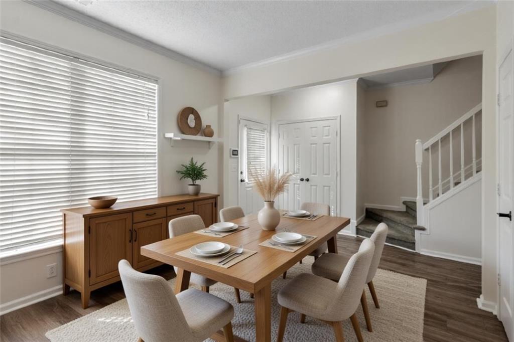 9155 Nesbit Ferry Road, Unit 96 Alpharetta, GA 30022 - Photo 4 of 46 a view of a dining room with furniture and wooden floor