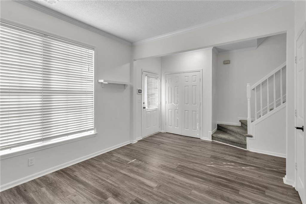 9155 Nesbit Ferry Road, Unit 96 Alpharetta, GA 30022 - Photo 8 of 46 a view of an empty room with wooden floor and a window