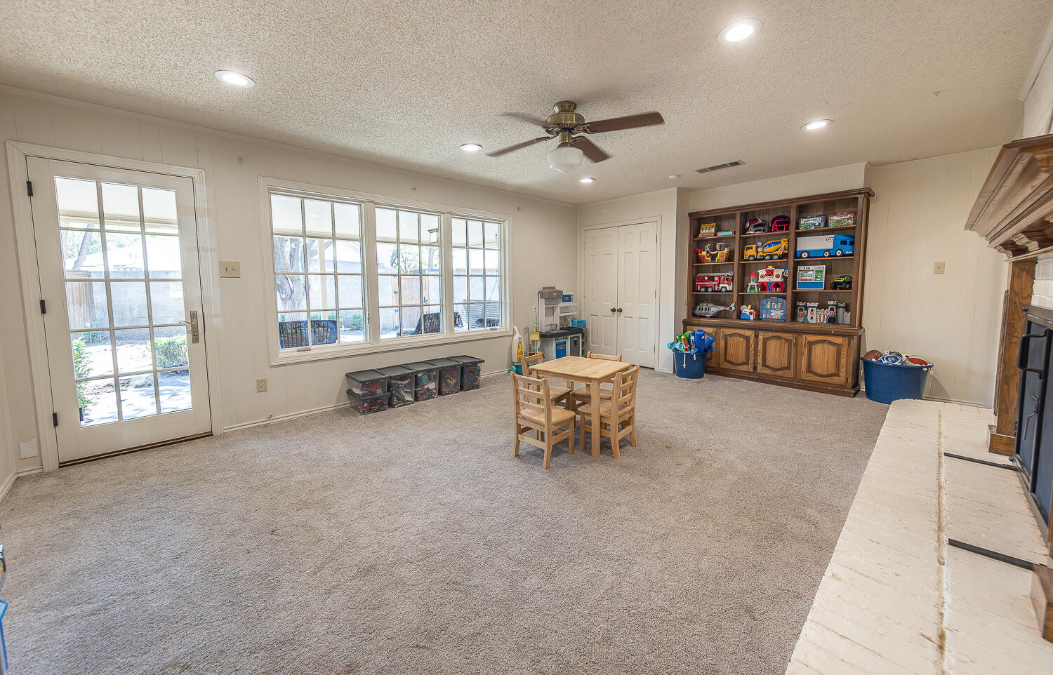 4411 88th Street Lubbock, TX 79424 - Photo 13 of 38 a living room with furniture and a flat screen tv