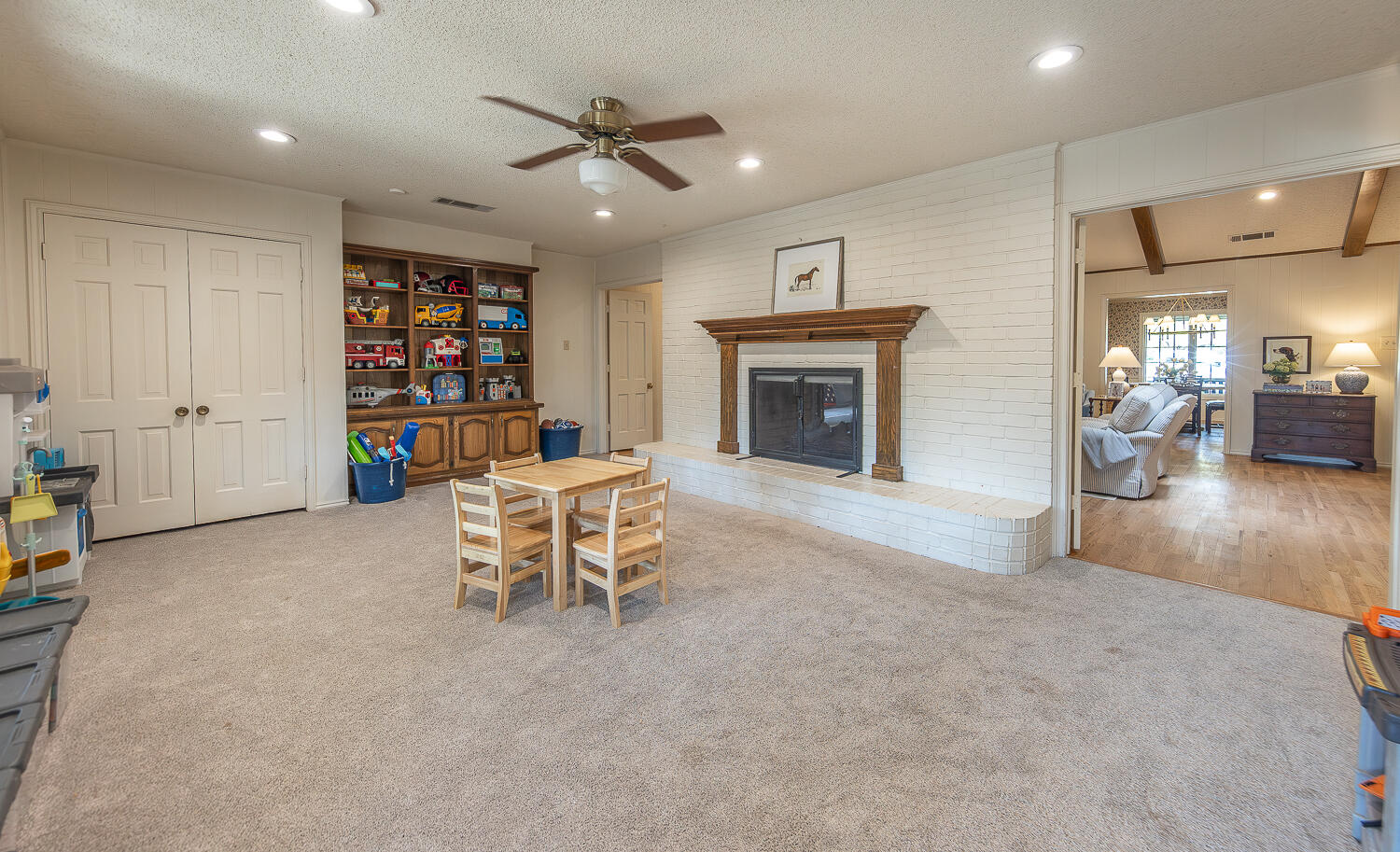 4411 88th Street Lubbock, TX 79424 - Photo 14 of 38 a living room with furniture and a fireplace
