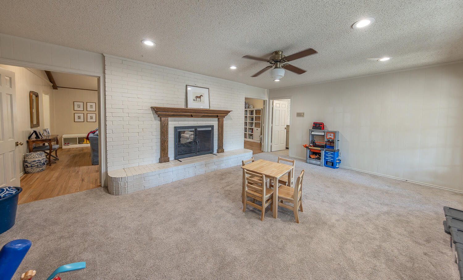4411 88th Street Lubbock, TX 79424 - Photo 15 of 38 a living room with furniture and a fireplace