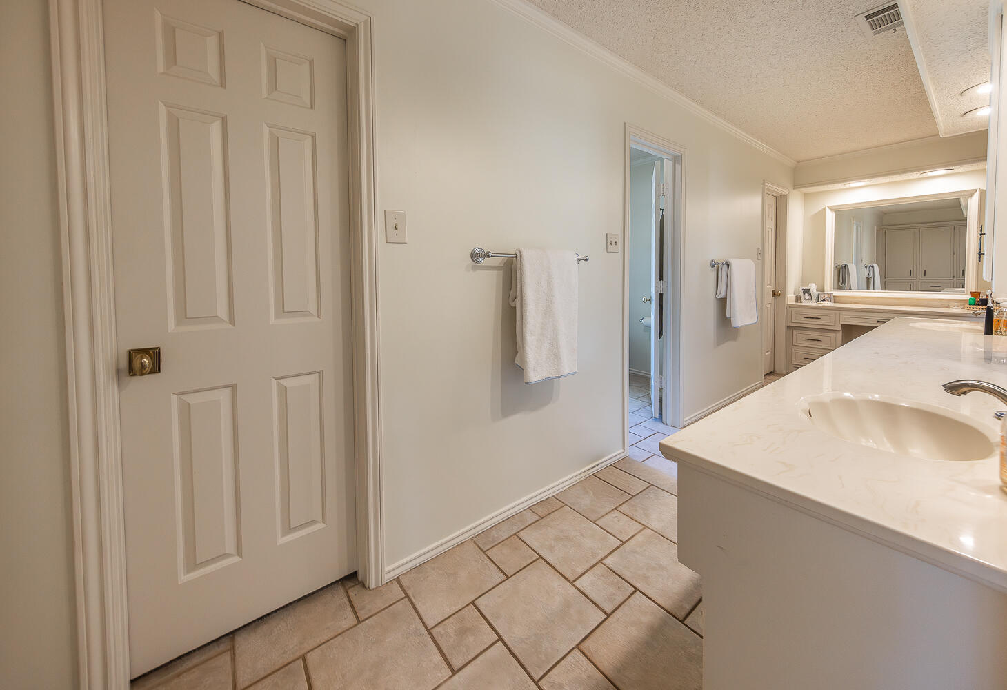 4411 88th Street Lubbock, TX 79424 - Photo 18 of 38 a bathroom with a sink and a mirror