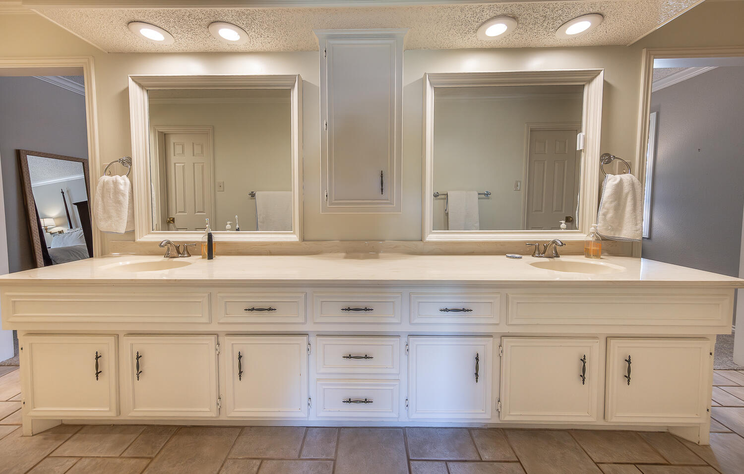4411 88th Street Lubbock, TX 79424 - Photo 19 of 38 a bathroom with white cabinets