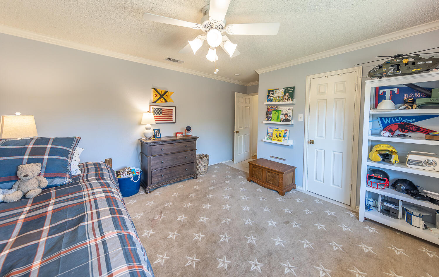 4411 88th Street Lubbock, TX 79424 - Photo 24 of 38 a bedroom with furniture and a book shelf