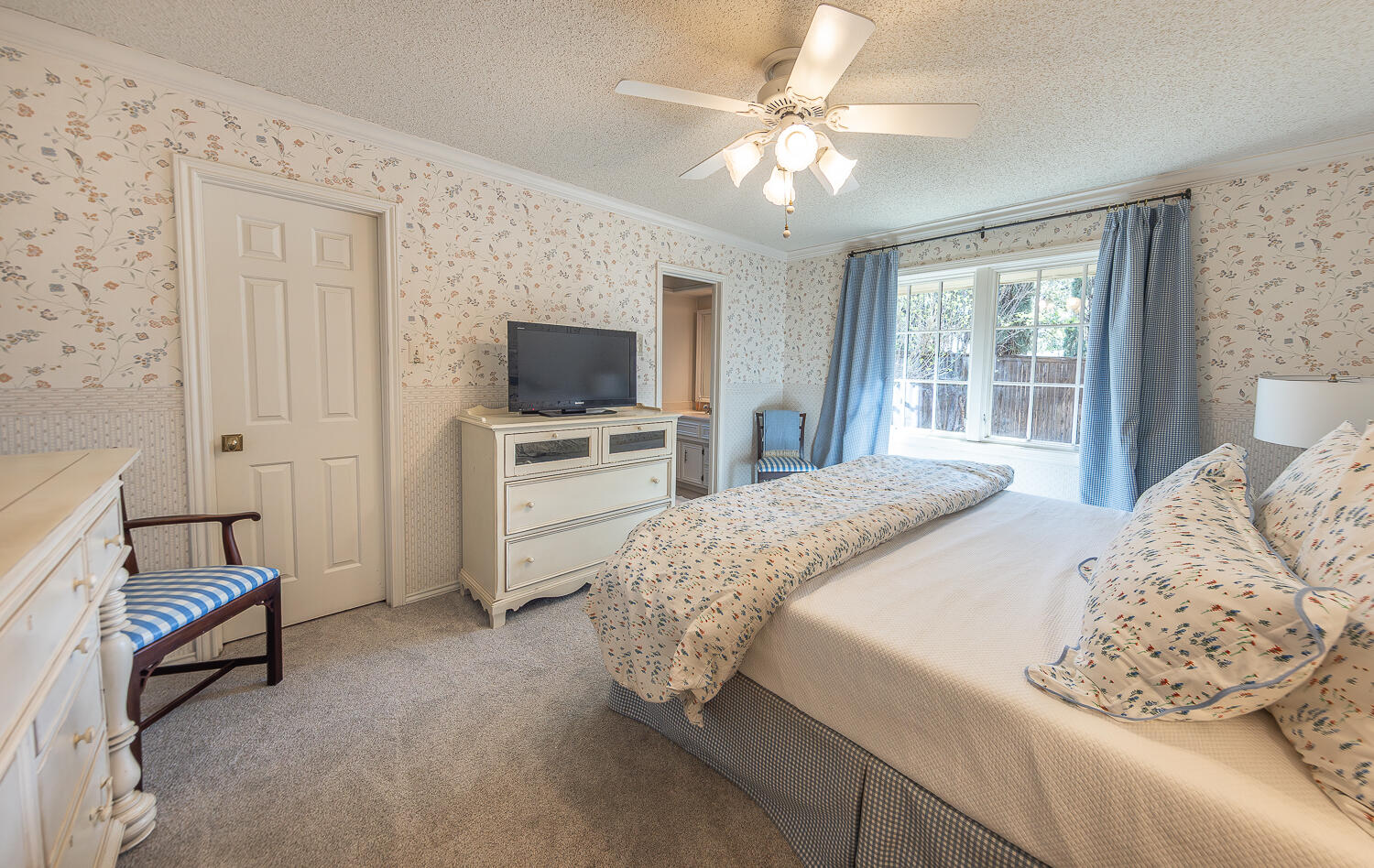4411 88th Street Lubbock, TX 79424 - Photo 25 of 38 a bedroom with a bed and a flat screen tv