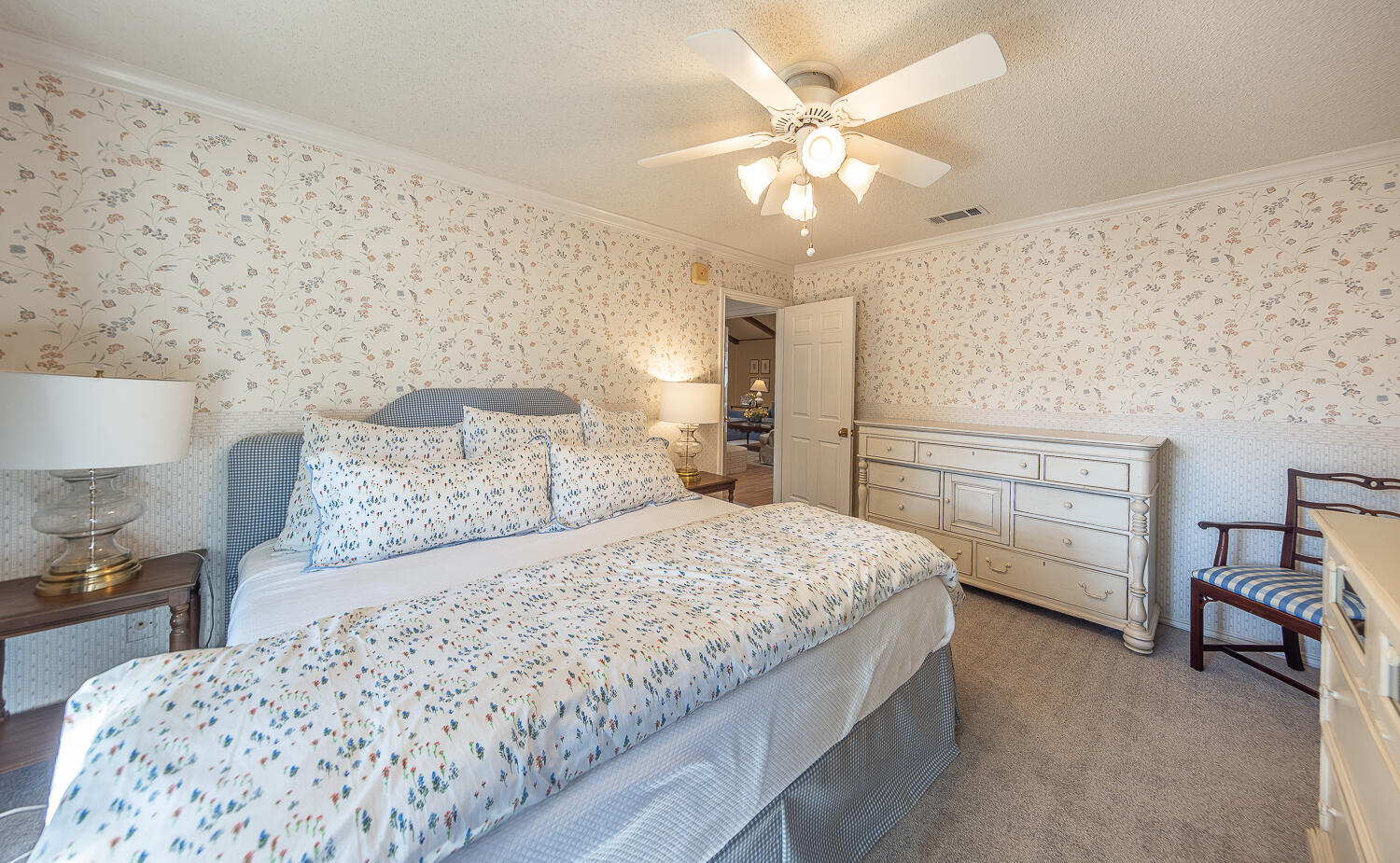4411 88th Street Lubbock, TX 79424 - Photo 26 of 38 a bedroom with a bed and a chandelier