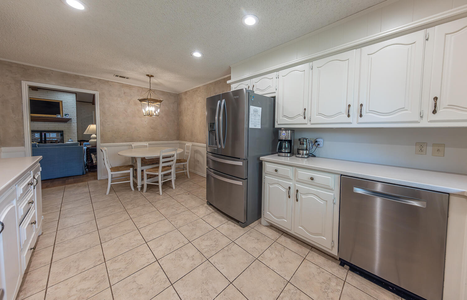 4411 88th Street Lubbock, TX 79424 - Photo 10 of 38 a kitchen with stainless steel appliances a refrigerator sink and cabinets