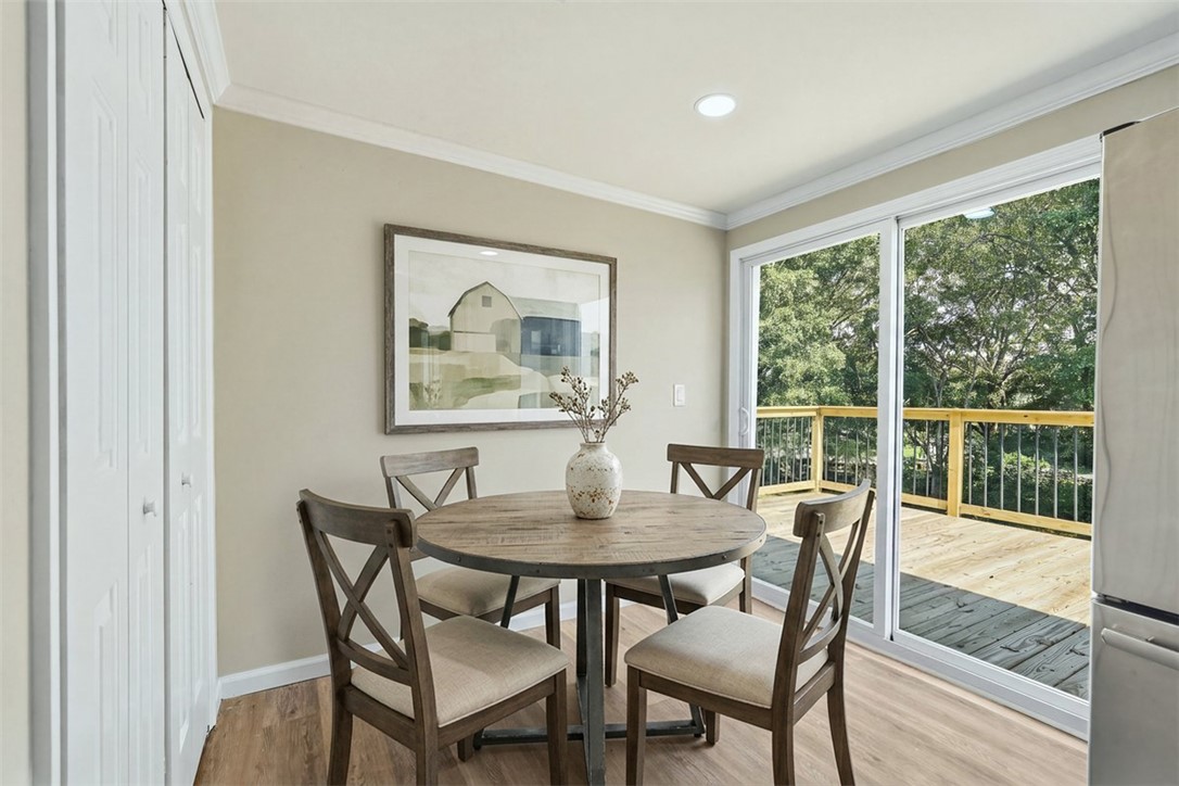 418 Old River Road Pelzer, SC 29669 - Photo 15 of 32 Sliding glass doors open from this dining space to an elevated wooden deck.