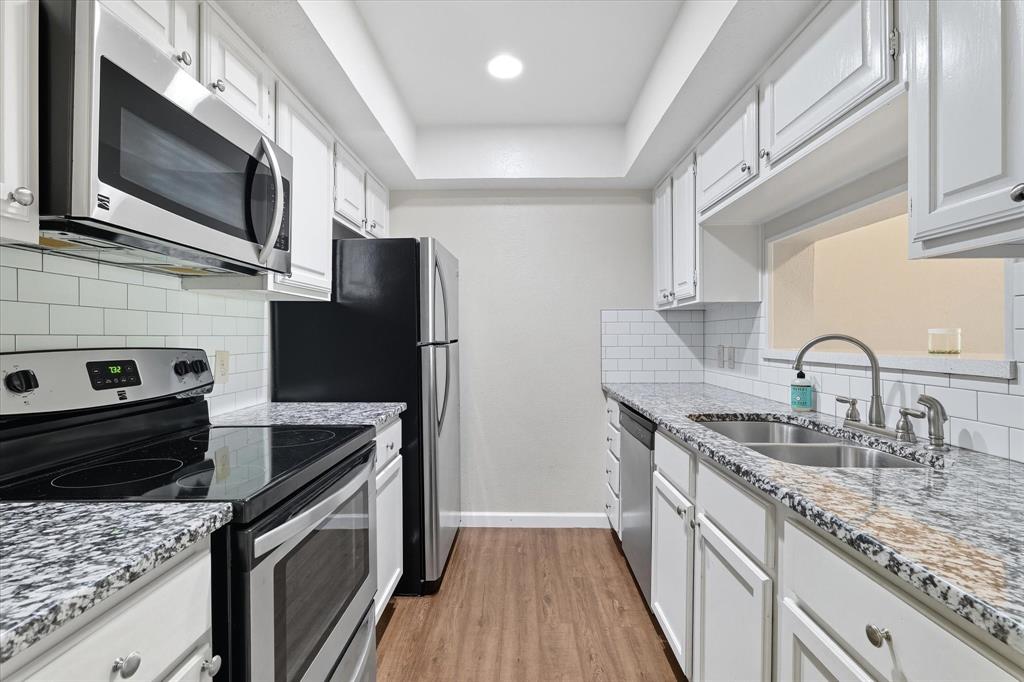 4539 North O'Connor Road, Unit 2234 Irving, TX 75062 - Photo 1 of 20 a kitchen with stainless steel appliances granite countertop a sink stove microwave and refrigerator