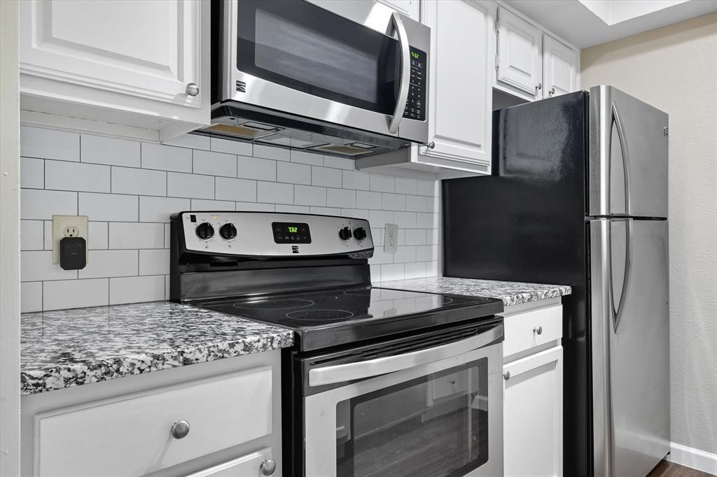 4539 North O'Connor Road, Unit 2234 Irving, TX 75062 - Photo 2 of 20 a kitchen with granite countertop cabinets and steel stainless steel appliances