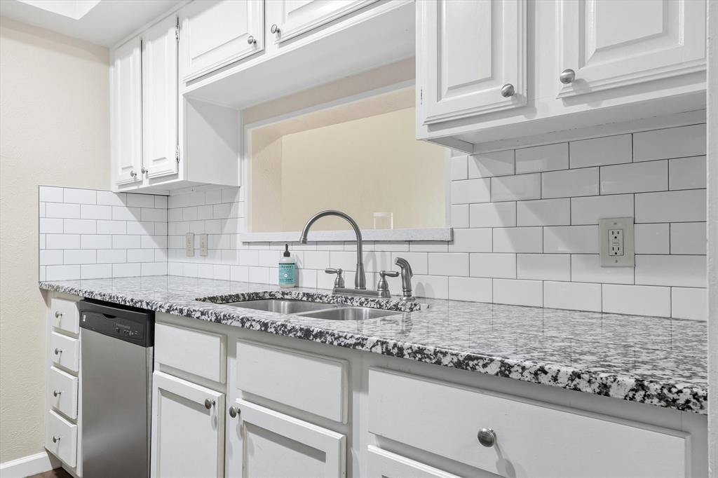 4539 North O'Connor Road, Unit 2234 Irving, TX 75062 - Photo 3 of 20 a kitchen with granite countertop a sink white cabinets and a stove