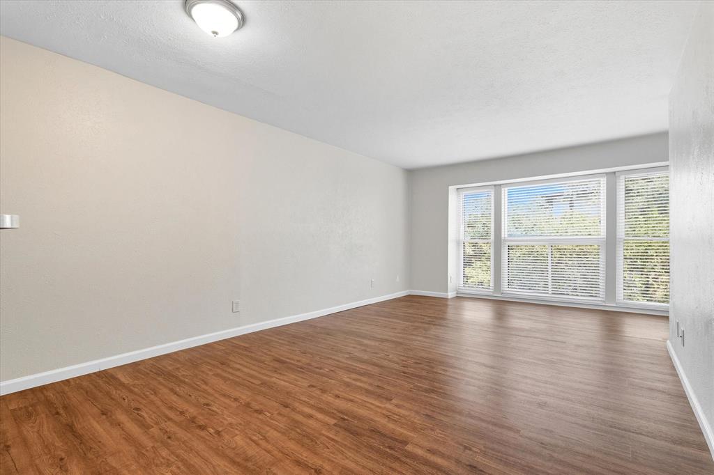 4539 North O'Connor Road, Unit 2234 Irving, TX 75062 - Photo 4 of 20 a view of an empty room with wooden floor and a window