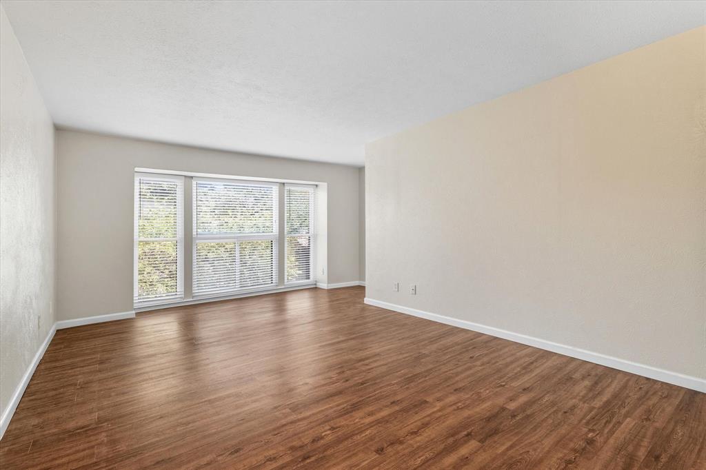 4539 North O'Connor Road, Unit 2234 Irving, TX 75062 - Photo 5 of 20 a view of an empty room with wooden floor and a window