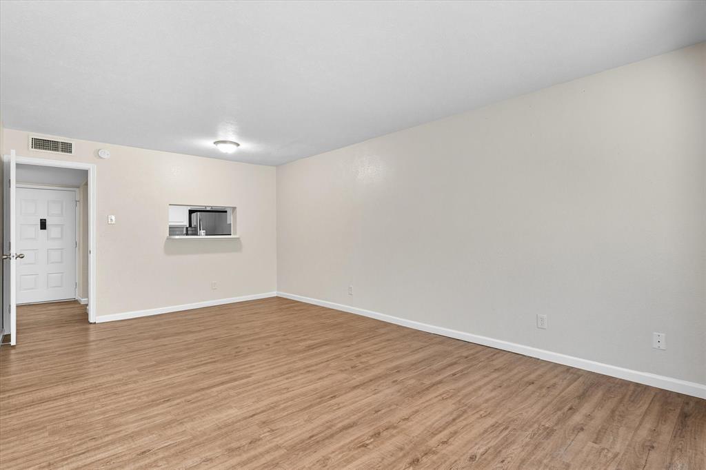 4539 North O'Connor Road, Unit 2234 Irving, TX 75062 - Photo 7 of 20 a view of an empty room with wooden floor