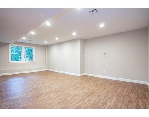 1 Aaron Road Lexington, MA 02421 - Photo 25 of 27 a view of an empty room with wooden floor and a window