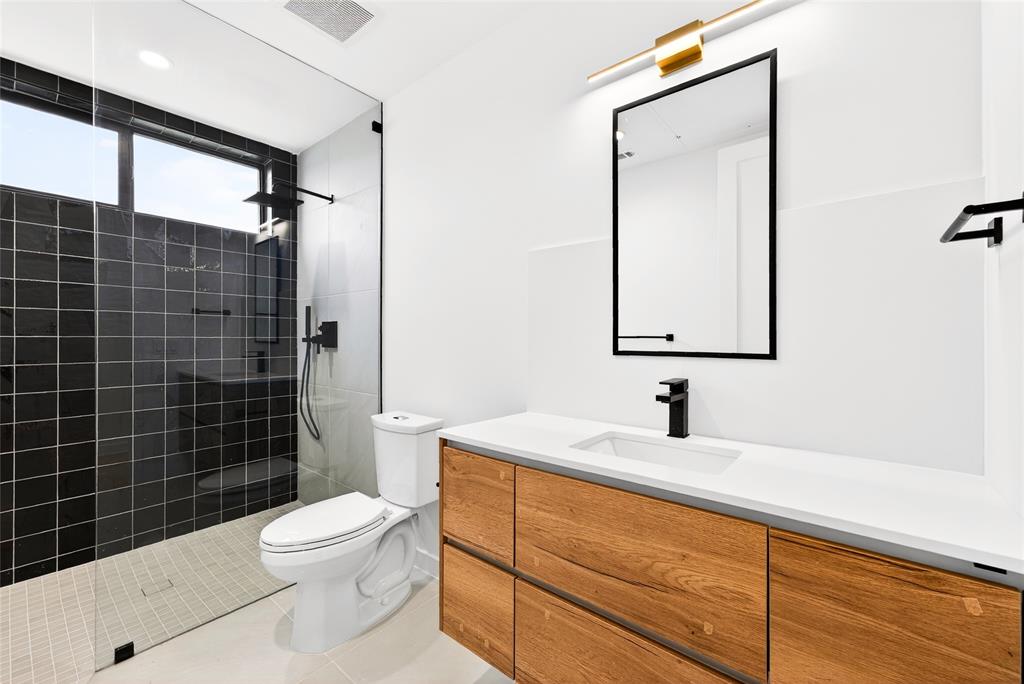 1111 Raiford Road, Unit 108 Carrollton, TX 75007 - Photo 19 of 39 a bathroom with a toilet sink shower and mirror