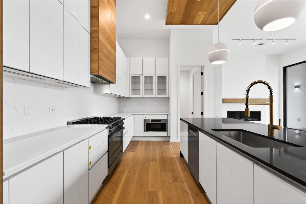1111 Raiford Road, Unit 108 Carrollton, TX 75007 - Photo 24 of 39 a kitchen with granite countertop a stove and a sink