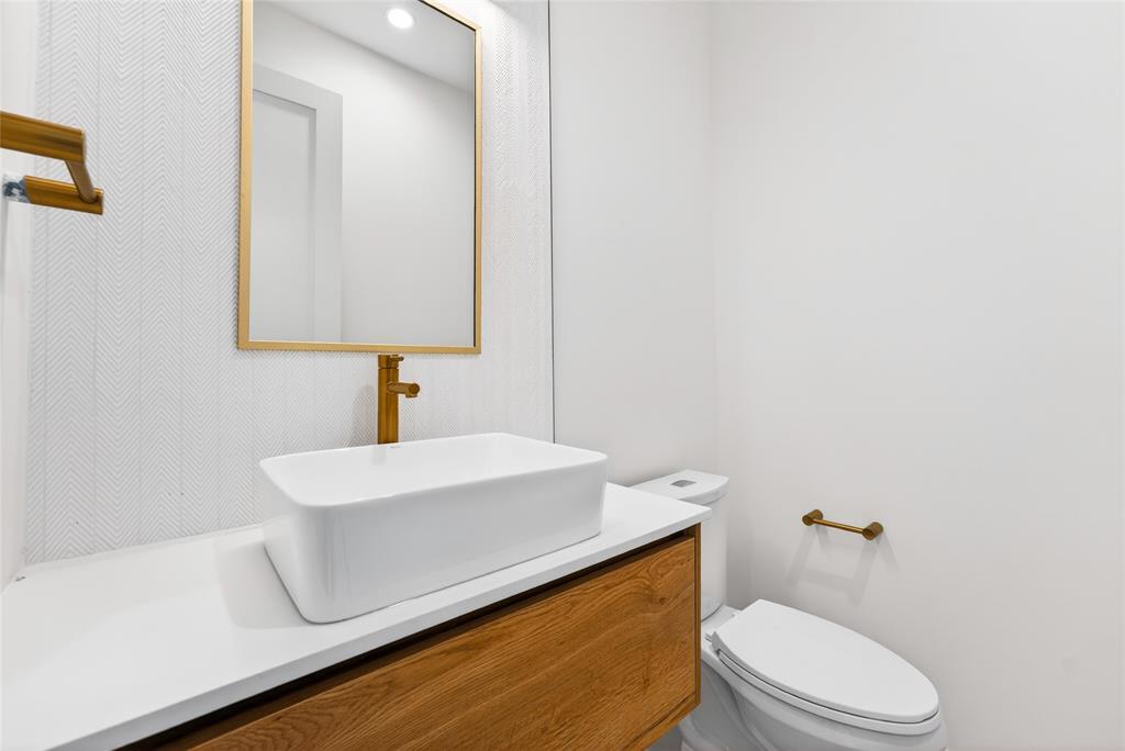 1111 Raiford Road, Unit 108 Carrollton, TX 75007 - Photo 26 of 39 a bathroom with a sink a toilet and mirror