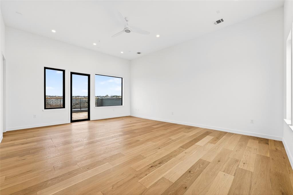 1111 Raiford Road, Unit 108 Carrollton, TX 75007 - Photo 31 of 39 a view of an empty room with wooden floor and a window