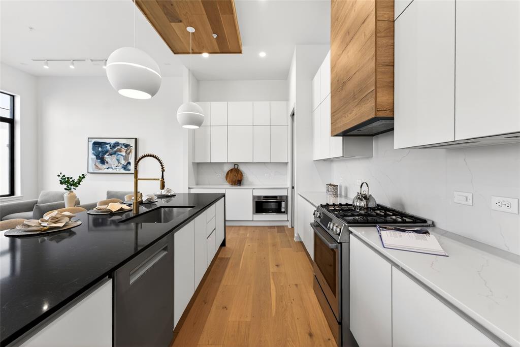 1111 Raiford Road, Unit 108 Carrollton, TX 75007 - Photo 6 of 39 a kitchen with granite countertop a sink a stove and cabinets