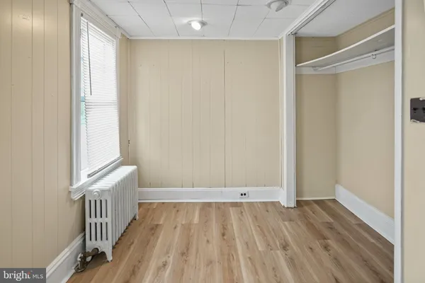 a view of hallway with wooden floor