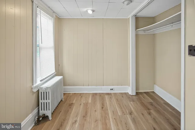a view of hallway with wooden floor