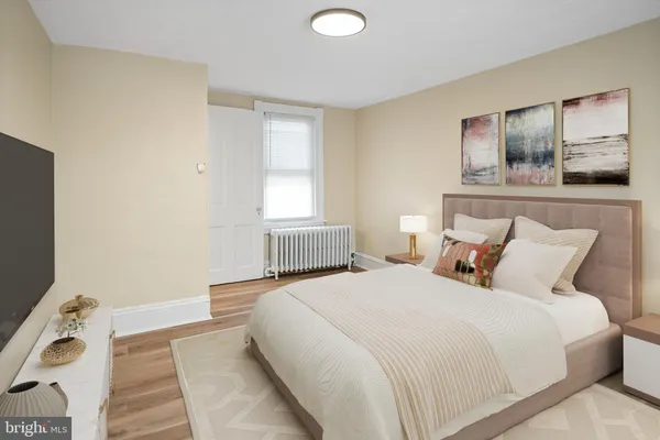 a bedroom with a large bed and a window