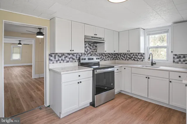 a kitchen with a sink stove and cabinets