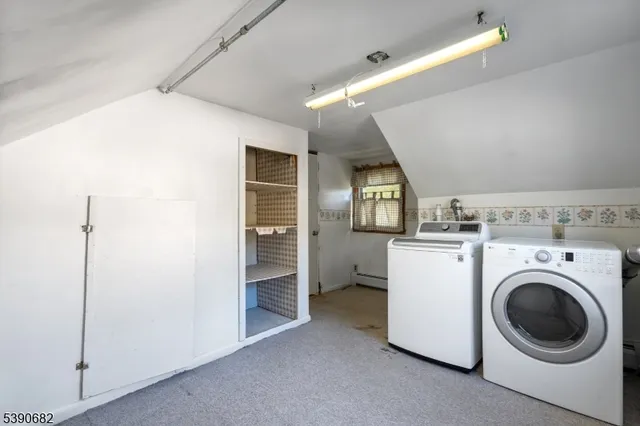 a view of a storage & utility room with washer and dryer