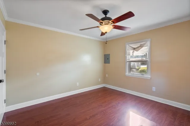 a view of a big room with wooden floor and windows