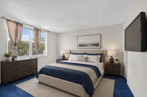 a bedroom with a large bed and a window