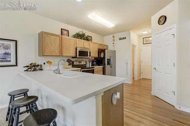 a kitchen with stainless steel appliances a stove refrigerator sink and cabinets