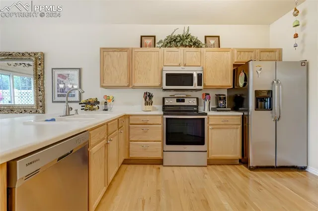 a kitchen with stainless steel appliances a stove microwave and a refrigerator