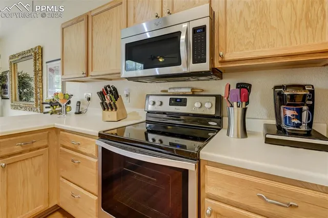 a kitchen with cabinets stainless steel appliances and a sink