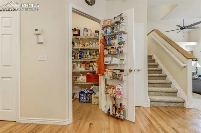 a view of a livingroom with lots of stuff and hardwood floor