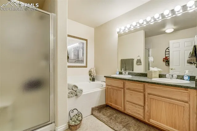 a spacious bathroom with a granite countertop sink a toilet and mirror