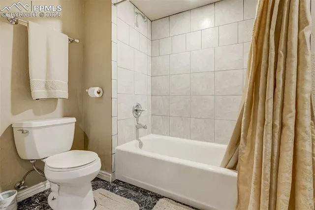 a bathroom with a toilet and a bathtub