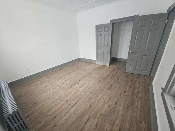 a view of wooden floor in an empty room